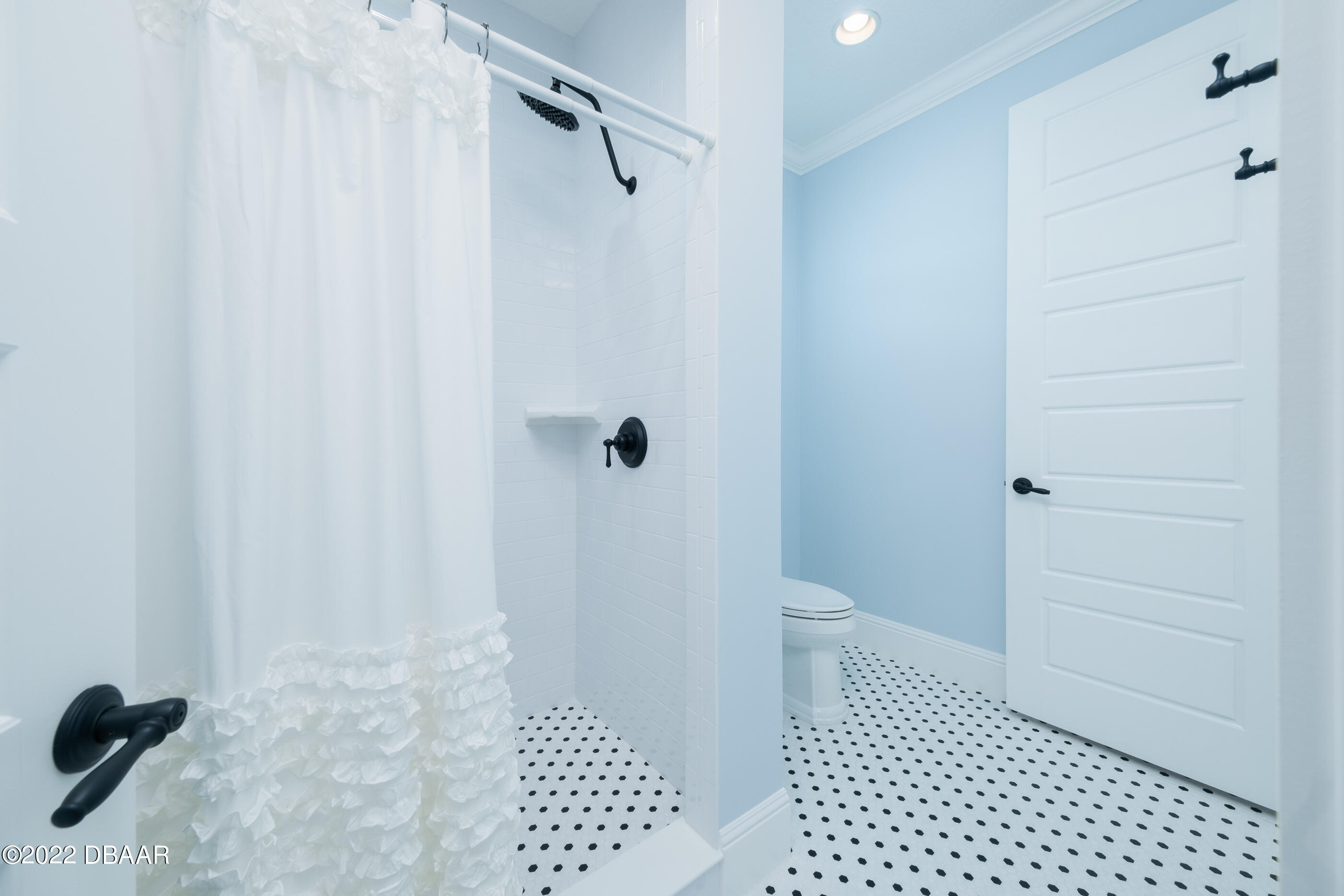 1212 South Riverside Drive New Smyrna Beach, FL 32168 - Photo 32 of 49 a bathroom with a sink a toilet a shower and a mirror