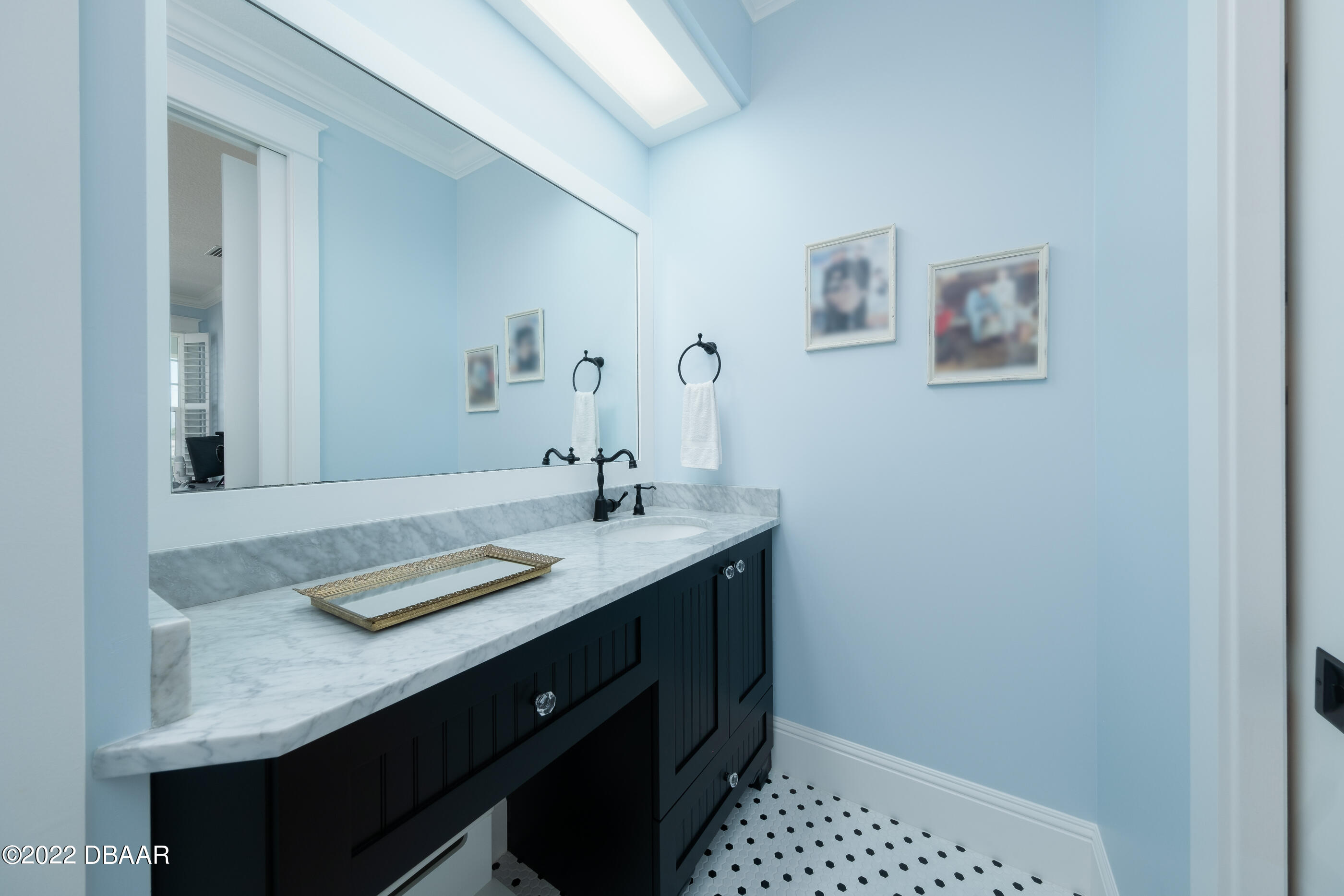 1212 South Riverside Drive New Smyrna Beach, FL 32168 - Photo 33 of 49 a bathroom with a sink a vanity and a mirror