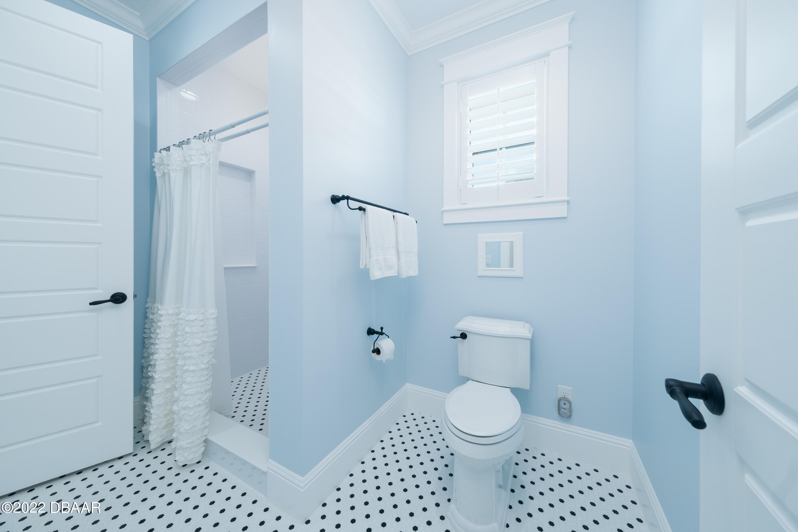 1212 South Riverside Drive New Smyrna Beach, FL 32168 - Photo 34 of 49 a bathroom with a toilet a window and shower