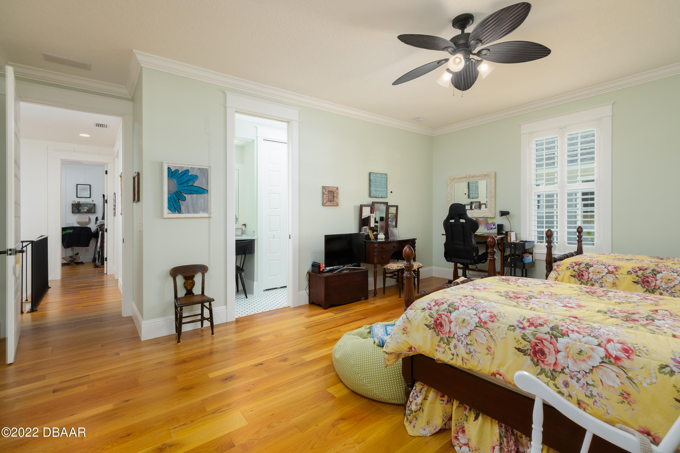 1212 South Riverside Drive New Smyrna Beach, FL 32168 - Photo 36 of 49 a bedroom with a bed a chandelier and a couch