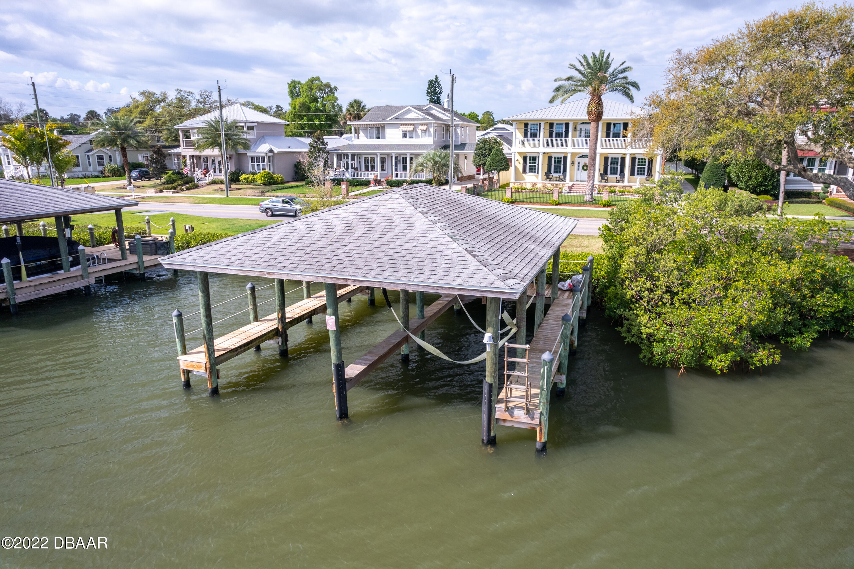 1212 South Riverside Drive New Smyrna Beach, FL 32168 - Photo 10 of 49 an aerial view of a house with swimming pool garden view and lake view