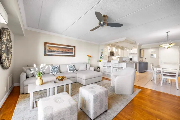 a living room with furniture and kitchen view