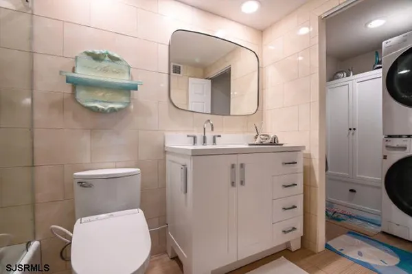 a bathroom with a toilet a sink a mirror and vanity