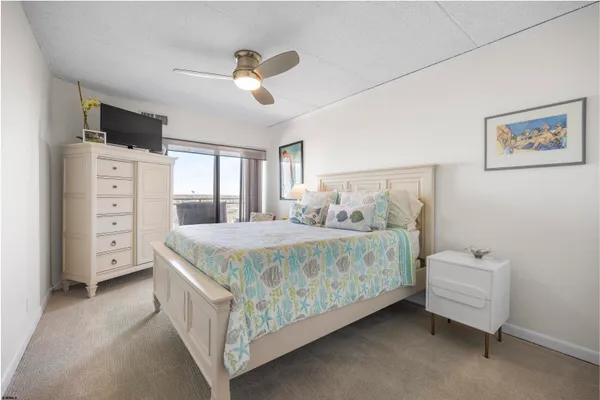 a bedroom with a bed and a tv