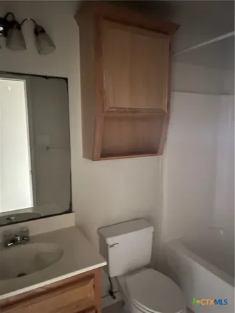 a bathroom with a shower and toilet