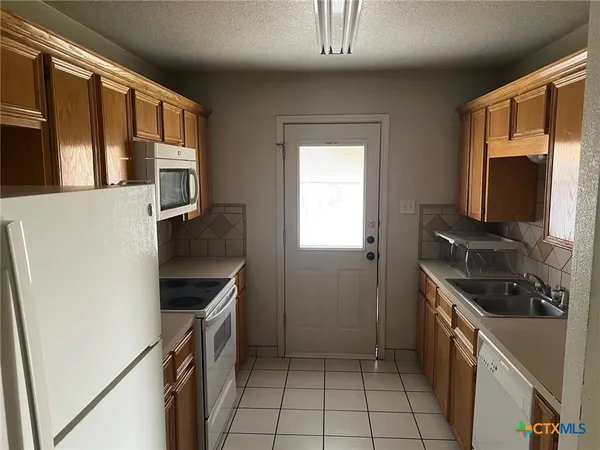 a kitchen with a stove and a microwave
