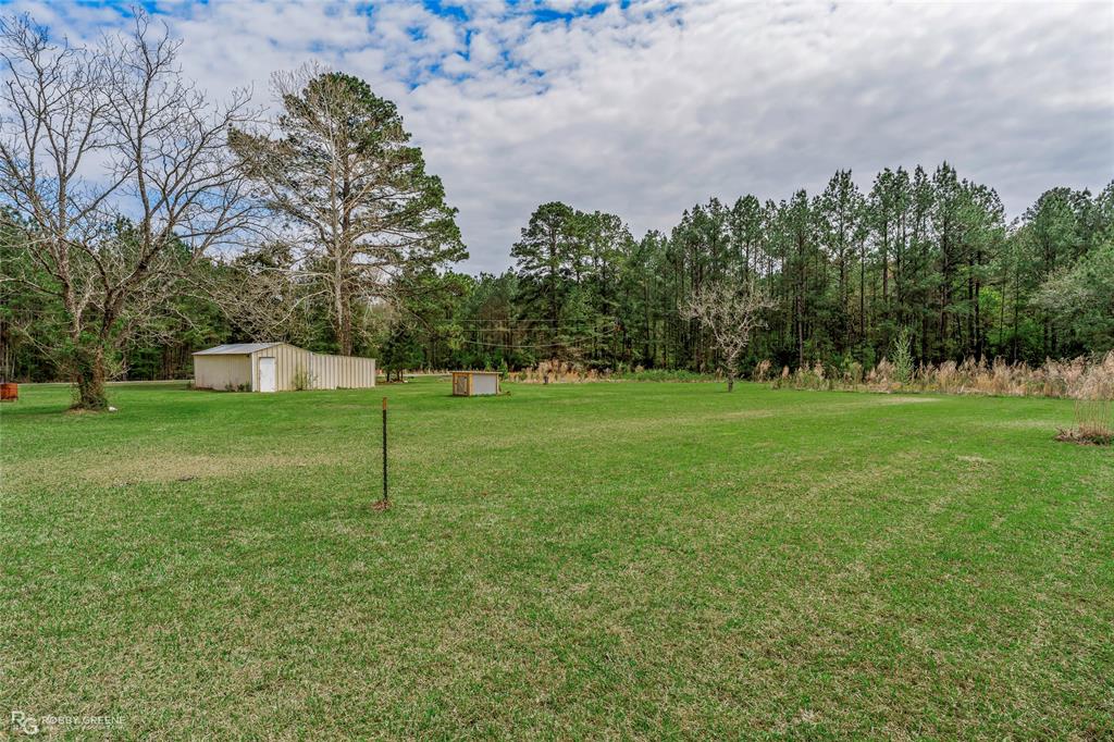 1303 Young Road Benton, LA 71006 - Photo 7 of 34 View of green lawn with an outdoor structure and an outbuilding