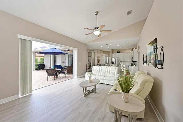 a living room with furniture a ceiling fan and a rug