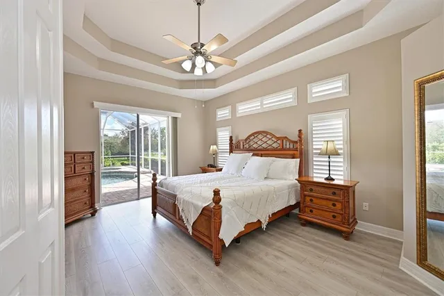a bedroom with a large bed and a chandelier