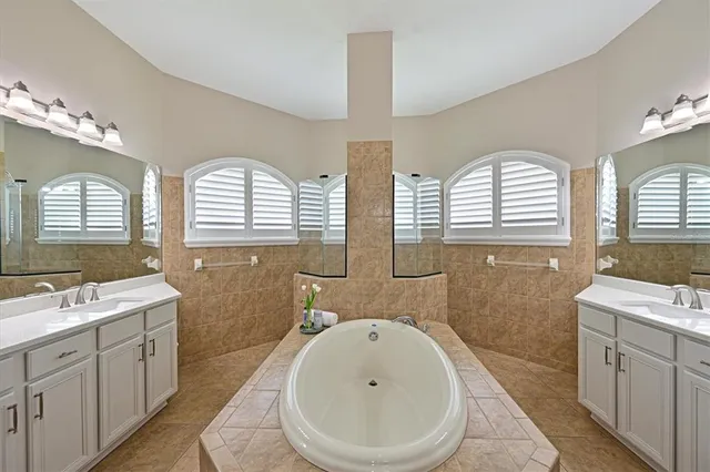 a bathroom with a double vanity sink a toilet and a mirror