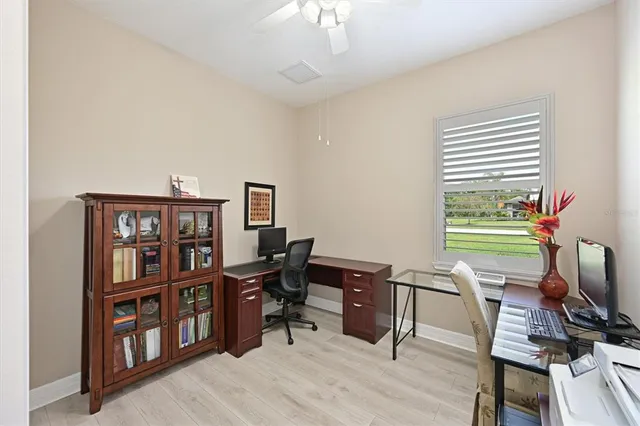 a view of a workspace with furniture and a bookshelf