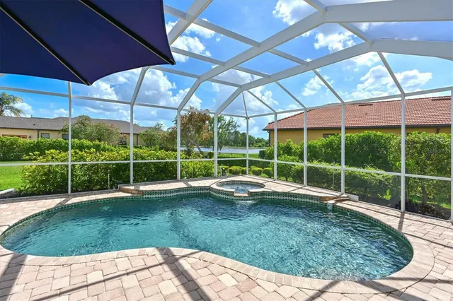 a view of a backyard with table and chairs under an umbrella