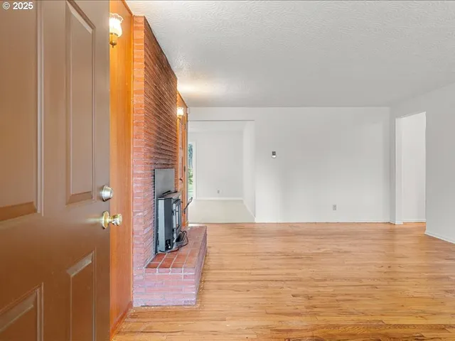 a view of a room with wooden floor and stairs