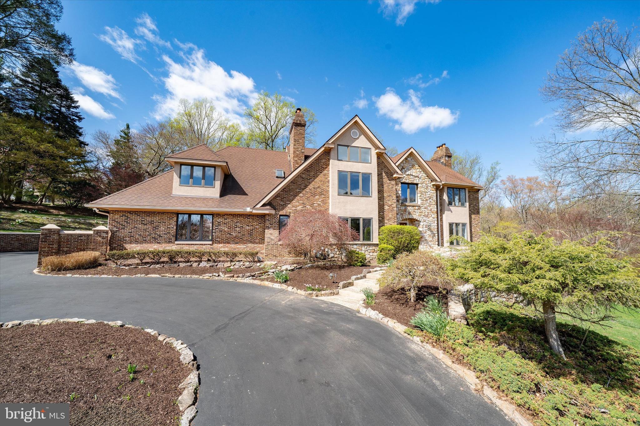 411 Hidden Valley Road Media, PA 19063 - Photo 13 of 90 a front view of a house with a yard and garage