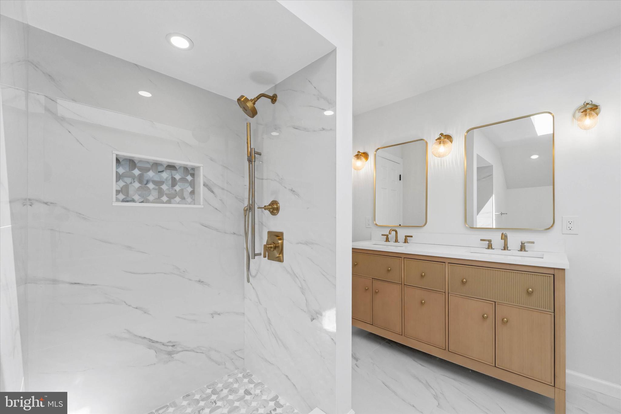 411 Hidden Valley Road Media, PA 19063 - Photo 55 of 90 a spacious bathroom with a double vanity sink a mirror a bathtub and next to a window