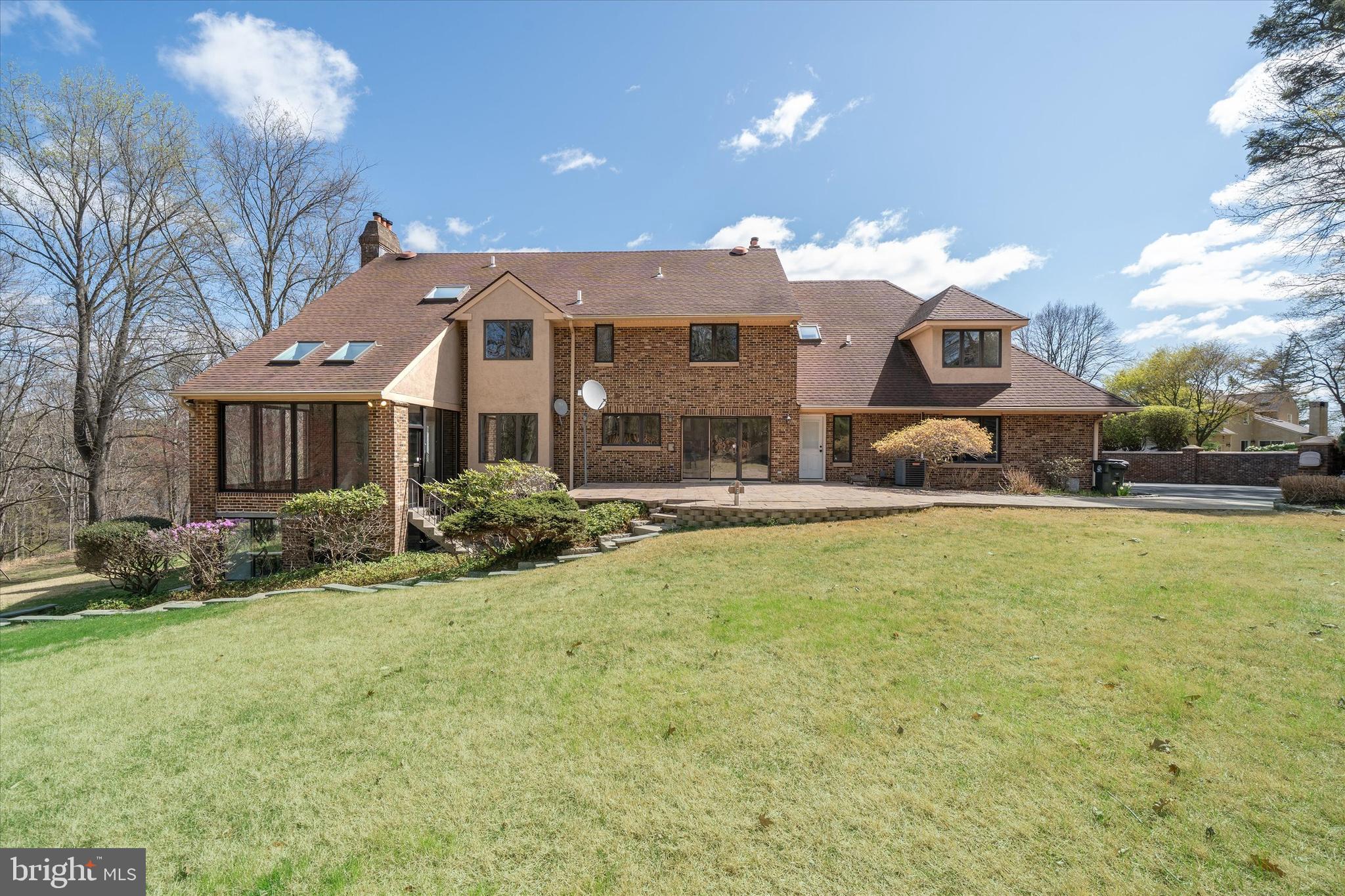 411 Hidden Valley Road Media, PA 19063 - Photo 81 of 90 a front view of a house with a yard and garage