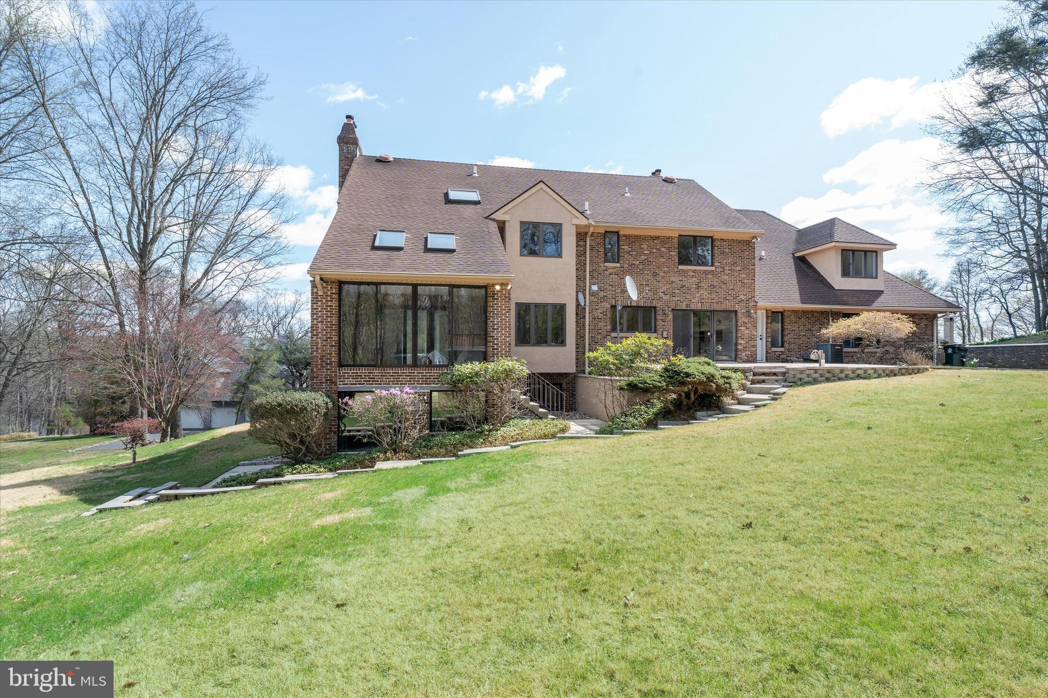 411 Hidden Valley Road Media, PA 19063 - Photo 82 of 90 a front view of a house with a yard and garage