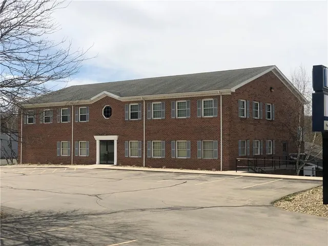 a front view of a house with a lots of windows