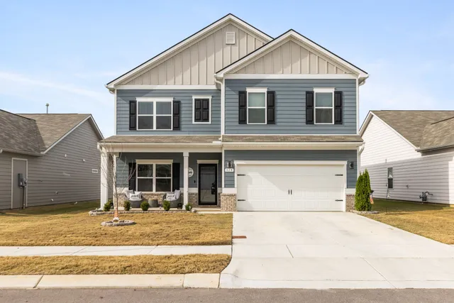 a front view of a house with outdoor seating