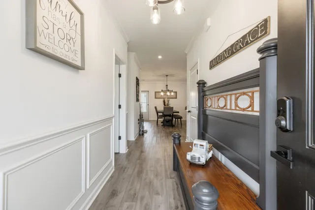 a view of a dining room with furniture wooden floor and chandelier