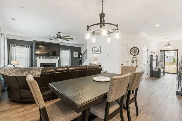 a dining room with furniture and wooden floor