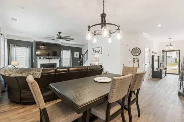 a dining room with furniture and wooden floor