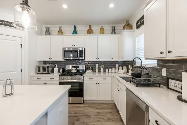 a kitchen with a stove and a microwave