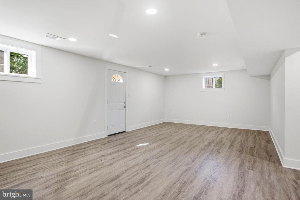 6620 Napoli Road Temple Hills, MD 20748 - Photo 26 of 38 a view of an empty room with wooden floor and a window