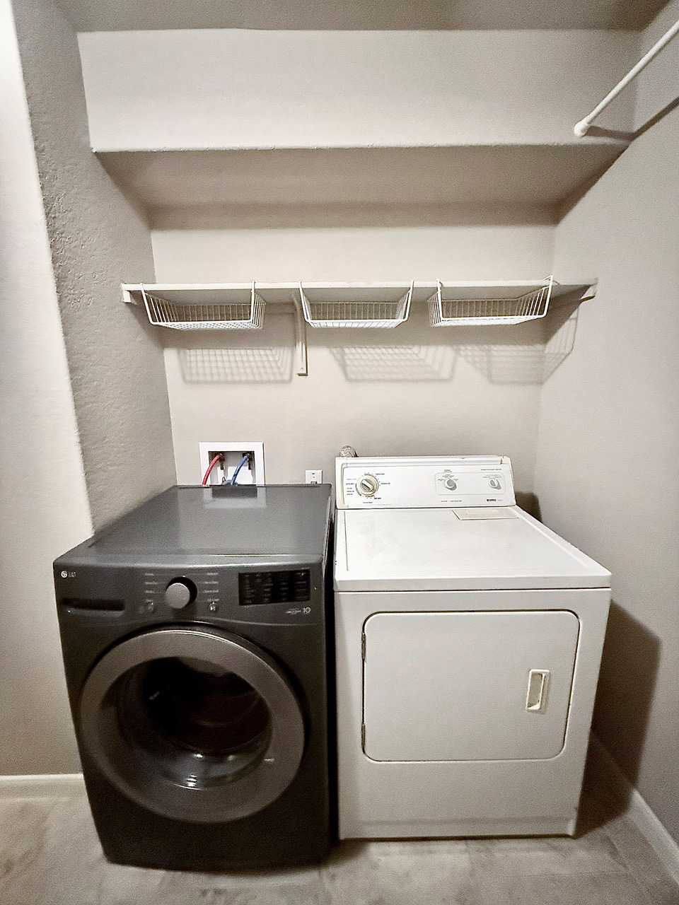 930 Pumpkin Ridge New Braunfels, TX 78130 - Photo 26 of 32 Dedicated laundry area featuring a washer and dryer hookups, overhead shelving, and a hanging rod