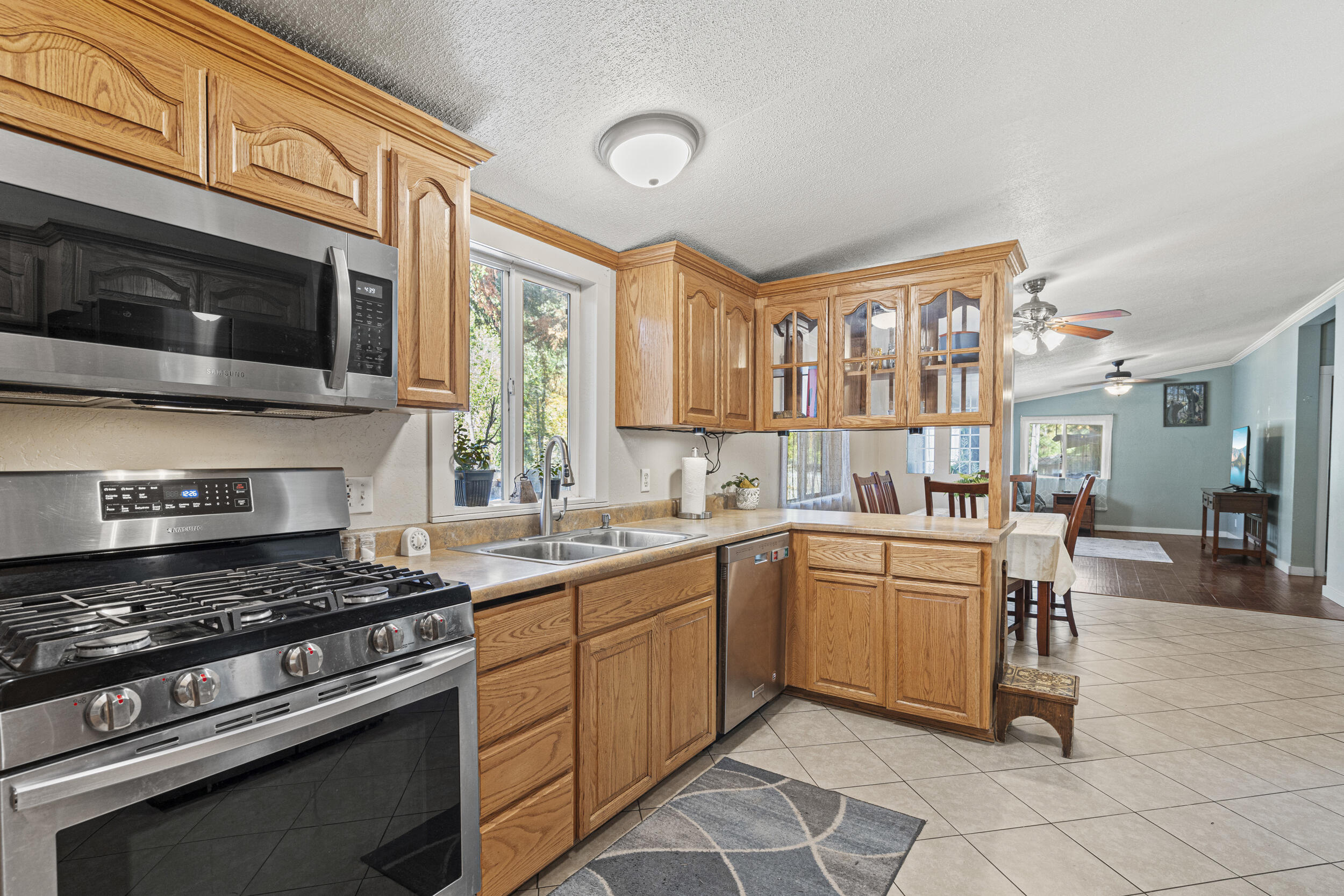 14100 Upper Applegate Road Jacksonville, OR 97530 - Photo 1 of 30 a kitchen with stainless steel appliances a stove sink and cabinets