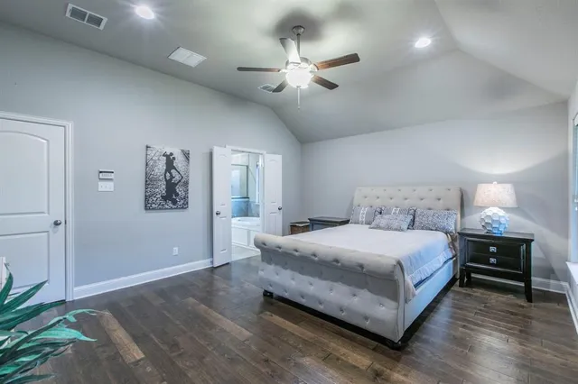 a bedroom with a large bed chandelier and a window