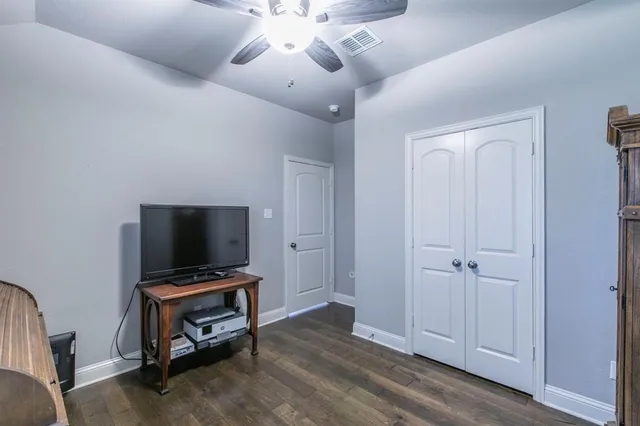 a view of workspace with wooden floor and ceiling fan