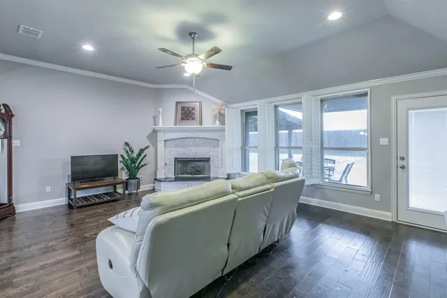 a living room with furniture a fireplace and a flat screen tv