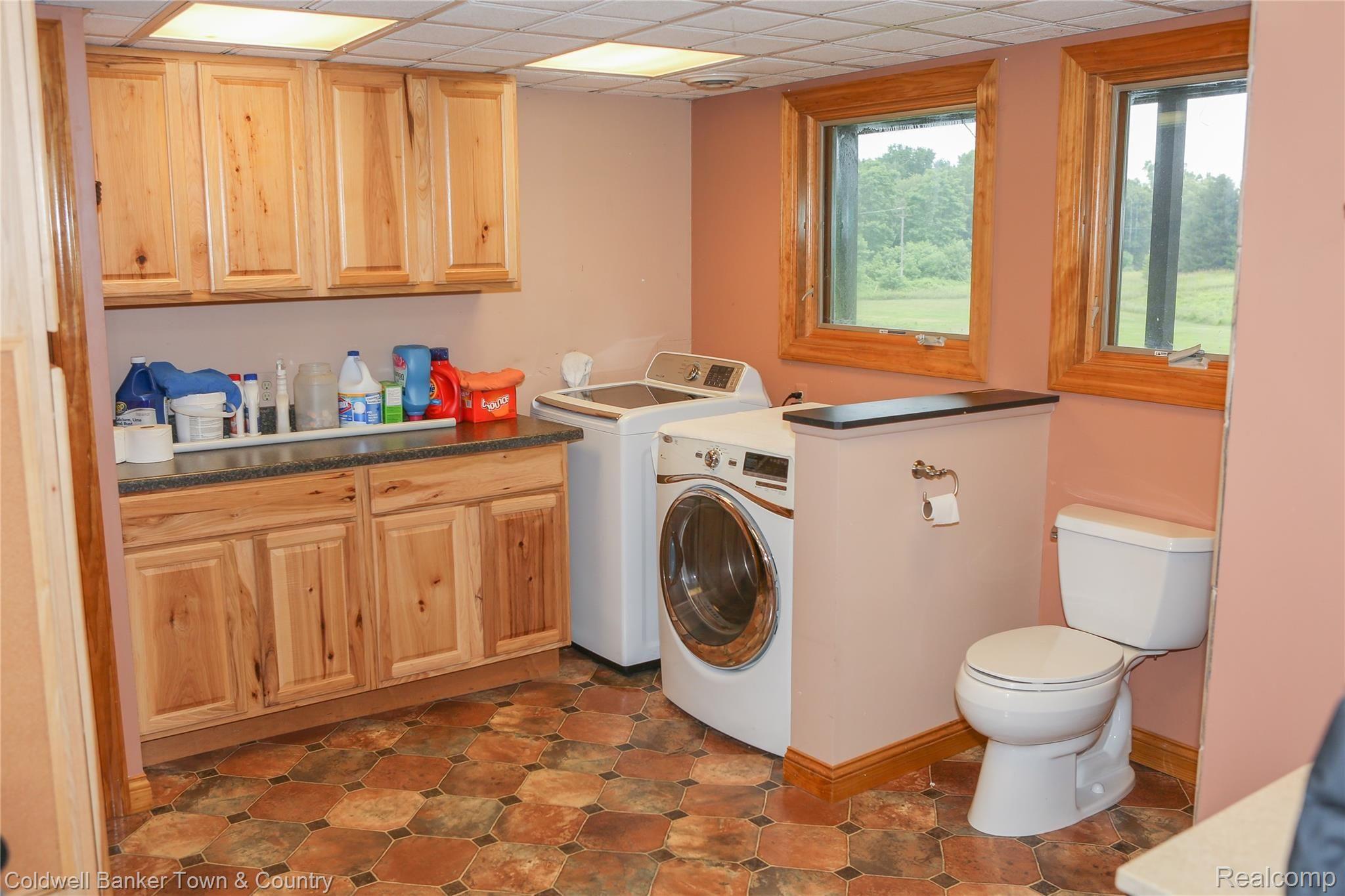 3188 West Coon Lake Road Howell, MI 48843 - Photo 56 of 65 Lower level laundry with full bath