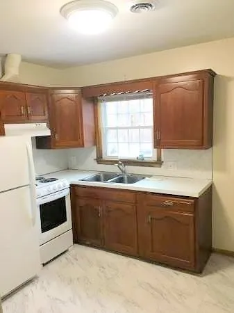 a kitchen with stainless steel appliances granite countertop a sink and a stove