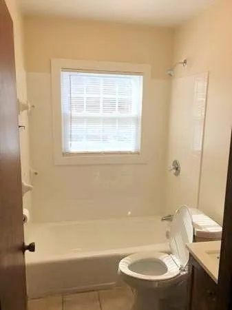 a bathroom with a toilet a sink and bathtub