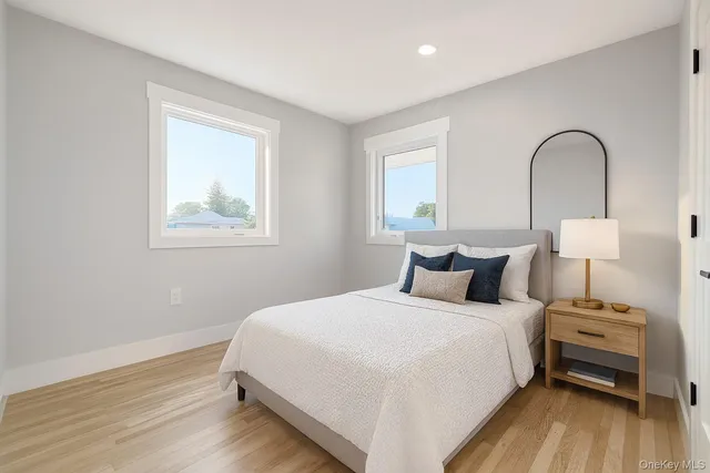a bedroom with bed and wooden floor