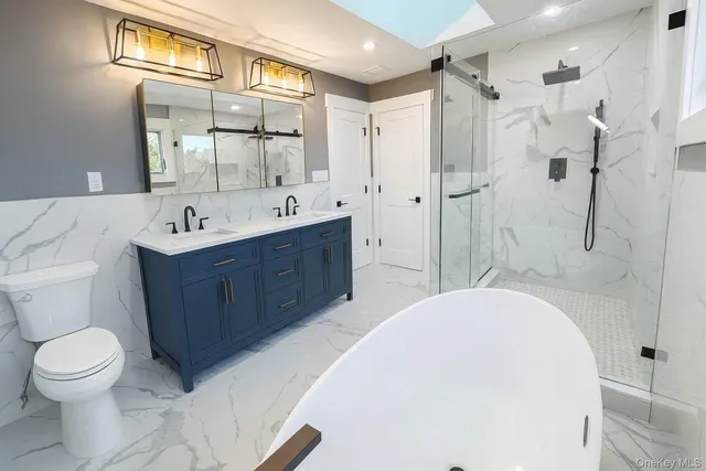 a bathroom with a sink toilet a mirror and shower
