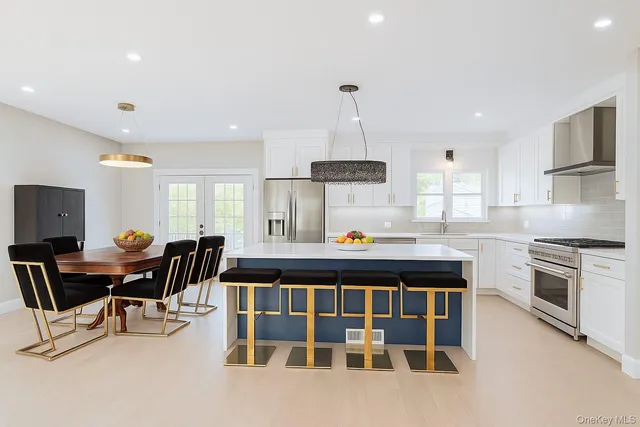 a kitchen with stainless steel appliances granite countertop a stove and a sink