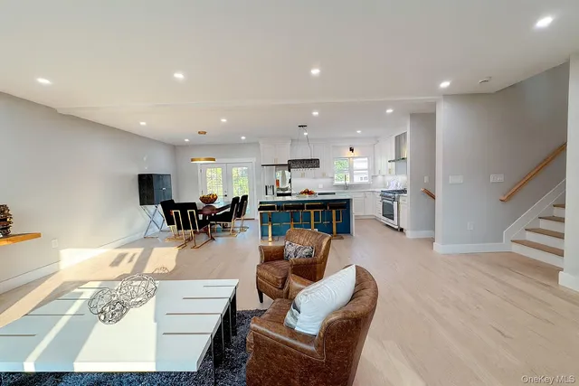 a living room with furniture and a dining table with kitchen view