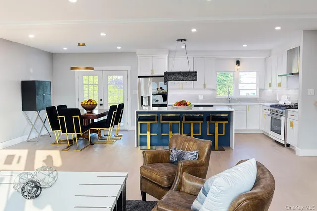 a living room with furniture a dining table and kitchen view