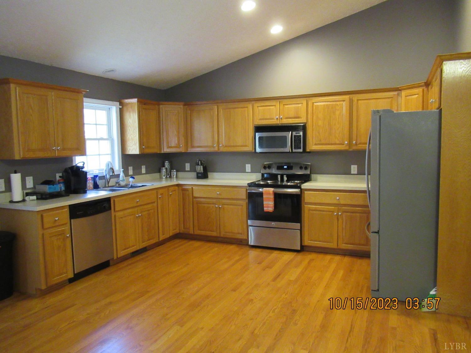 1360 Greenhouse Road Rustburg, VA 24588 - Photo 14 of 29 a kitchen with stainless steel appliances granite countertop a stove a sink dishwasher a refrigerator and a microwave