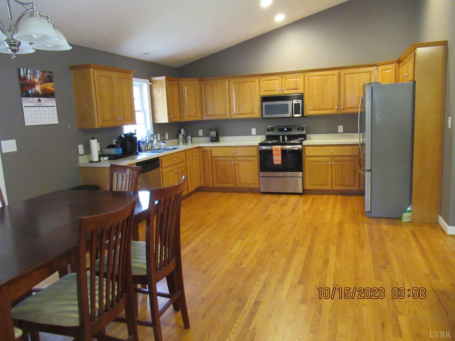 1360 Greenhouse Road Rustburg, VA 24588 - Photo 16 of 29 a kitchen with stainless steel appliances granite countertop a stove a sink a microwave and a refrigerator