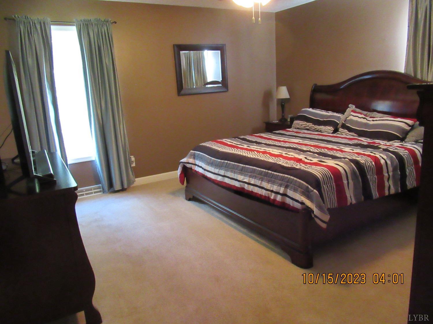 1360 Greenhouse Road Rustburg, VA 24588 - Photo 21 of 29 a bedroom with a bed and a mirror