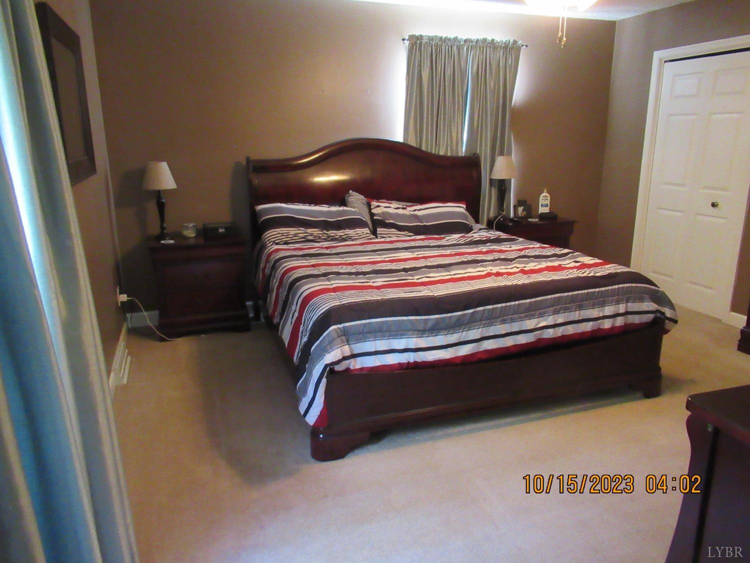 1360 Greenhouse Road Rustburg, VA 24588 - Photo 22 of 29 a bedroom with a bed and wooden floor