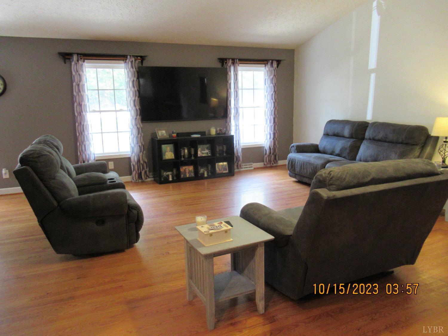 1360 Greenhouse Road Rustburg, VA 24588 - Photo 8 of 29 a living room with furniture a flat screen tv and a window