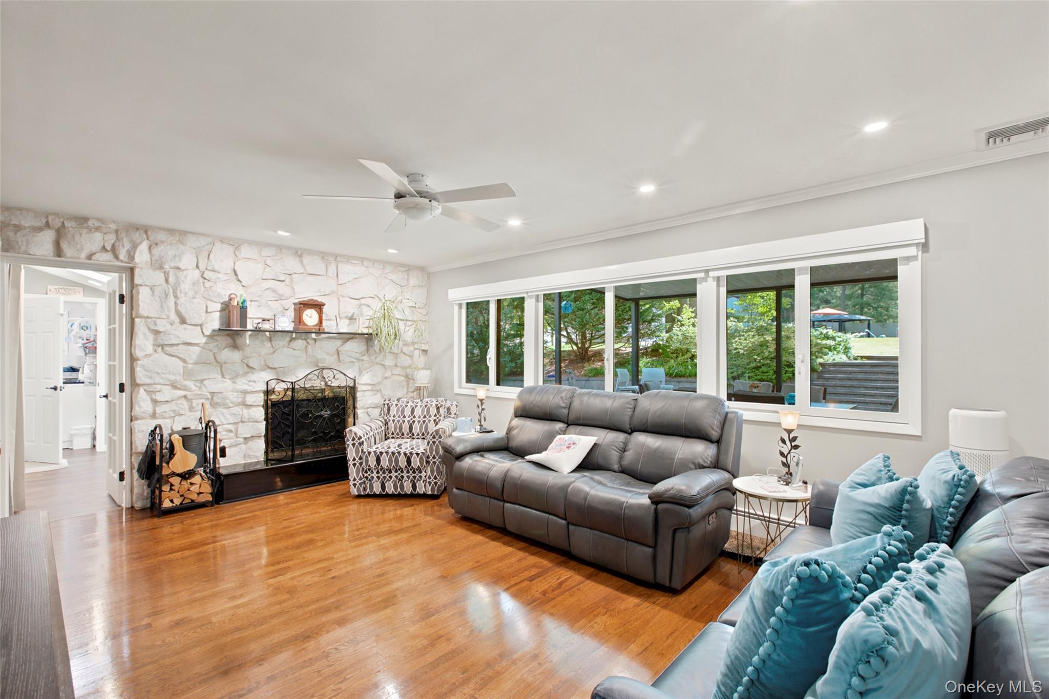 17 Lower Road Smithtown, NY 11787 - Photo 6 of 29 family room with wood burning fireplace and entrance to laundry/mud room