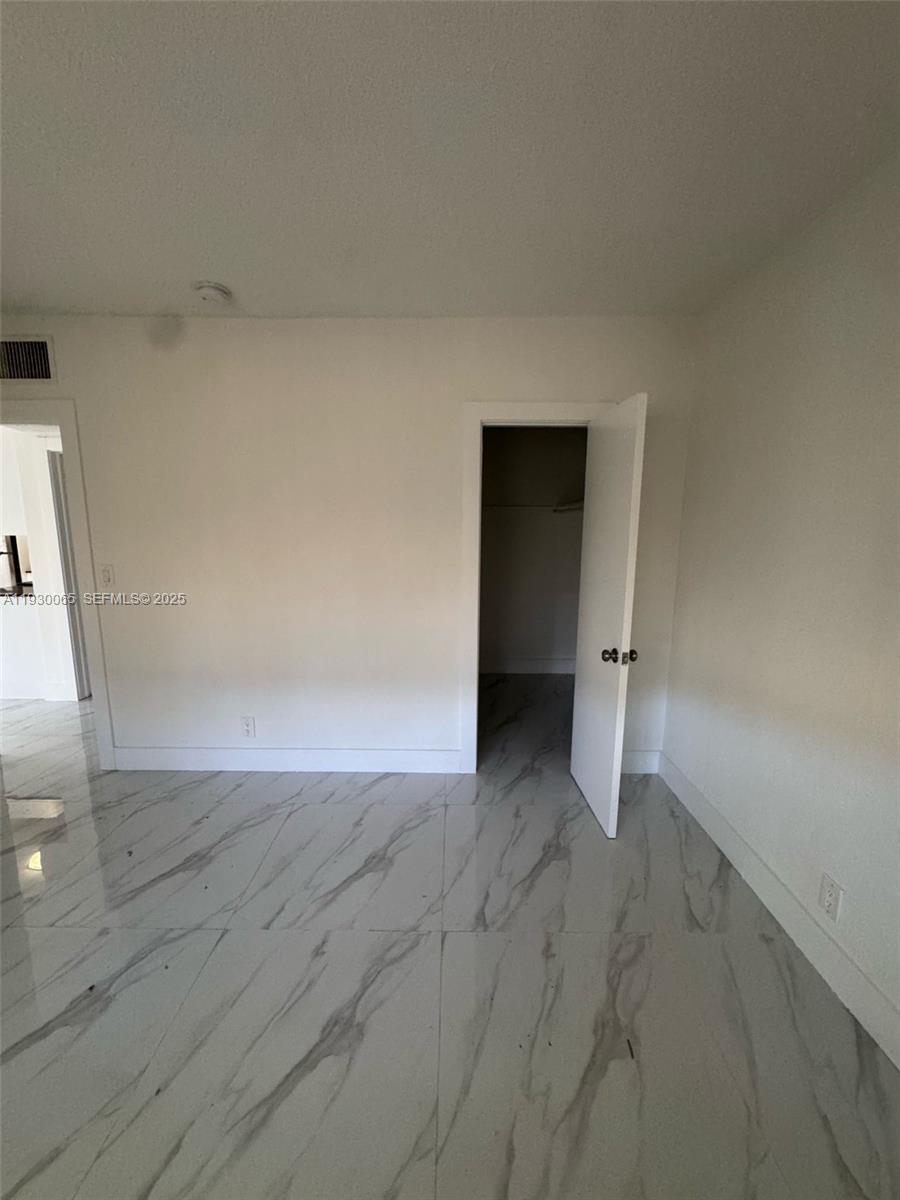 5731 Northeast 18th Avenue, Unit 4 Fort Lauderdale, FL 33334 - Photo 6 of 13 a view of an empty room and wooden floor