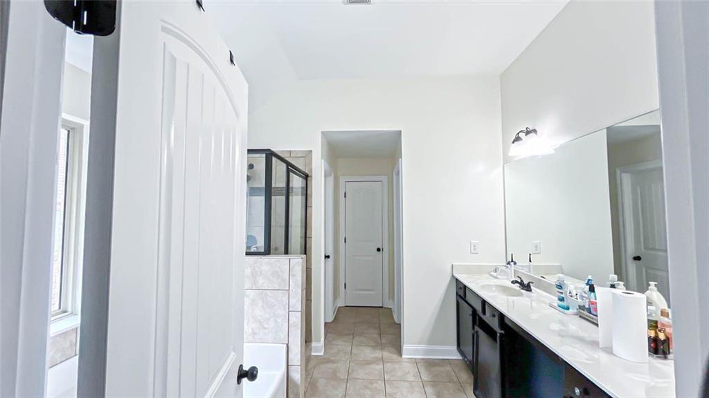 3281 Alhambra Circle Hampton, GA 30228 - Photo 45 of 88 a en suite bathroom with a double vanity sink a toilet and a mirror