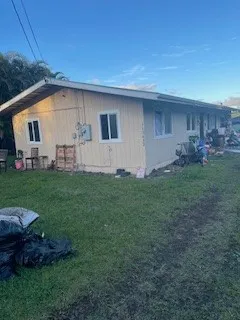 a front view of house with a garden